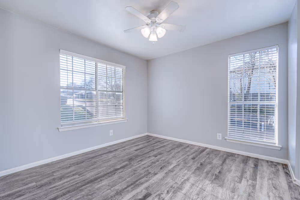 Bedroom with two large windows.