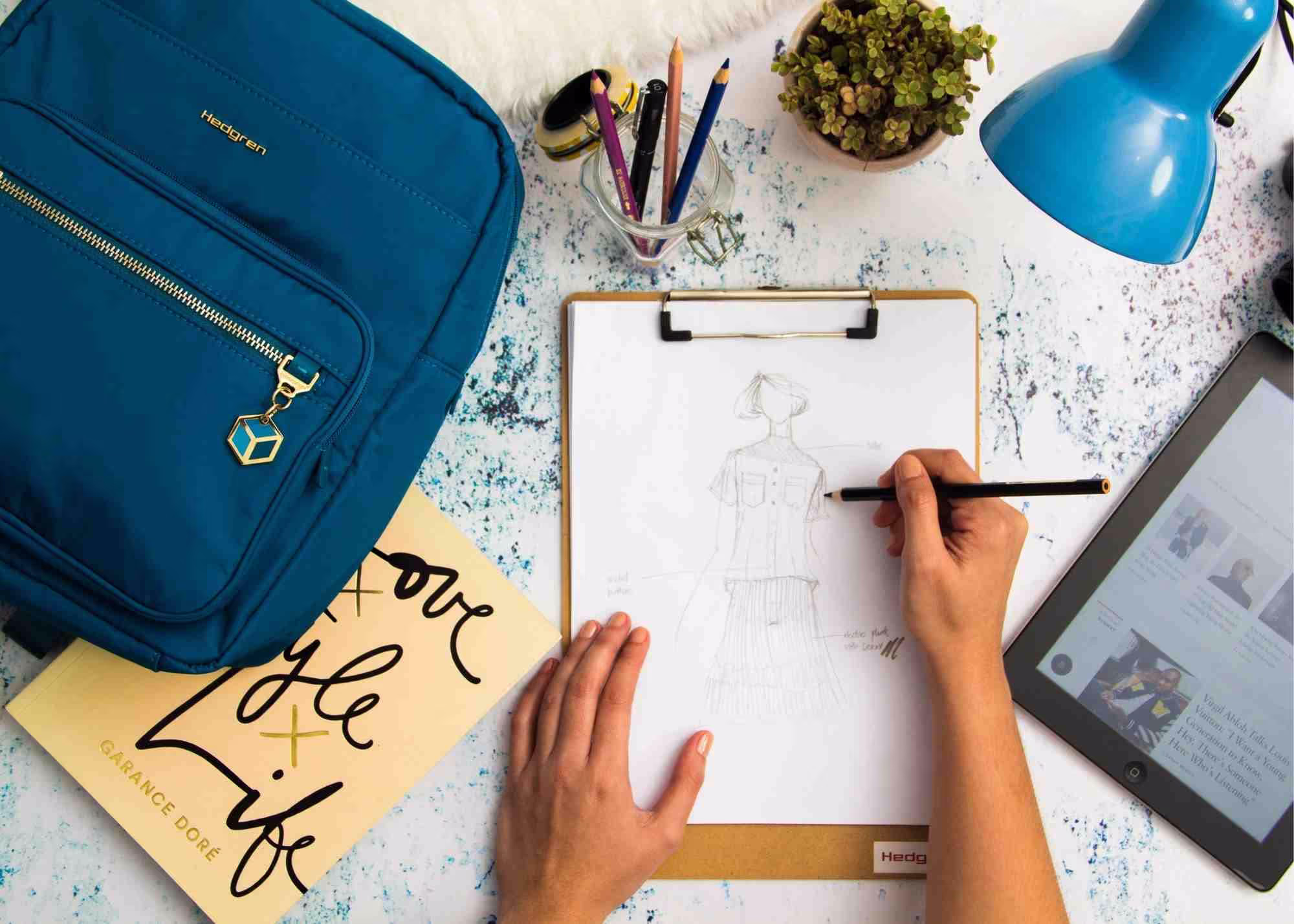 A student working on their homework with supplies scattered around their desk.